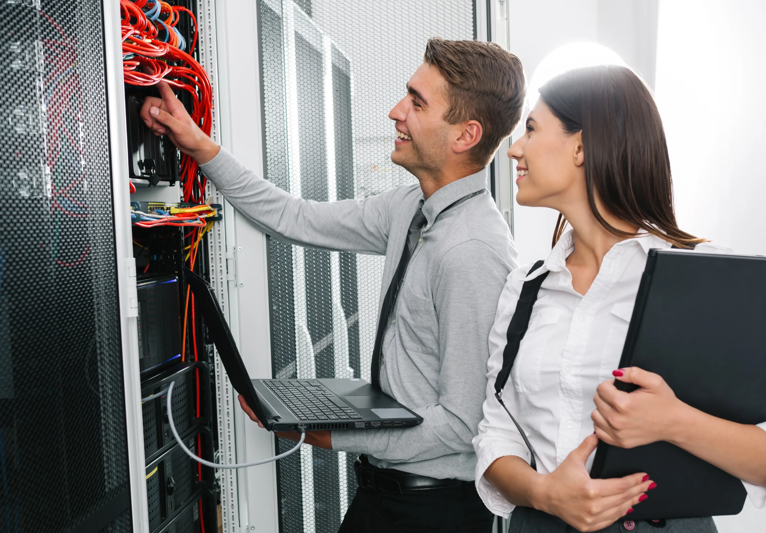 Two IT professionals confidently manage server equipment, ensuring a smooth, stress-free modernization of IT infrastructure