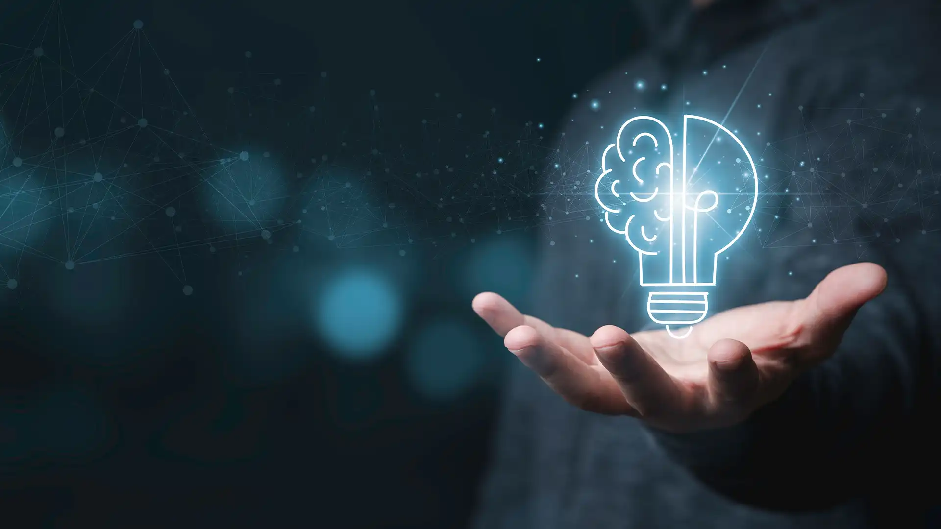 A holographic brain within a lightbulb floating above a hand, symbolizing Nimbl Networks' innovative solutions transforming IT management challenges into success